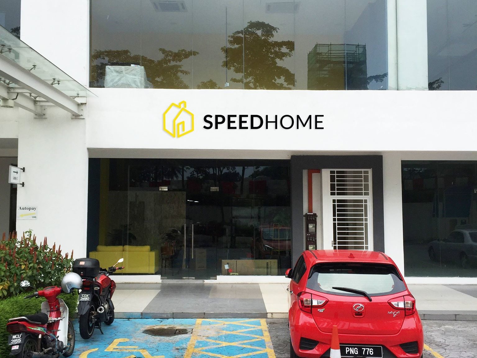 The yellow SPEEDHOME entrance door at Block A, Lobby 2 of Eve Suite, Ara Damansara — the on-site marker used to identify the SPEEDHOME office when arriving by car, Grab or on foot from Lembah Subang LRT.