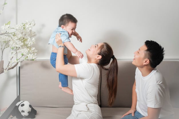 Happy family with baby at home